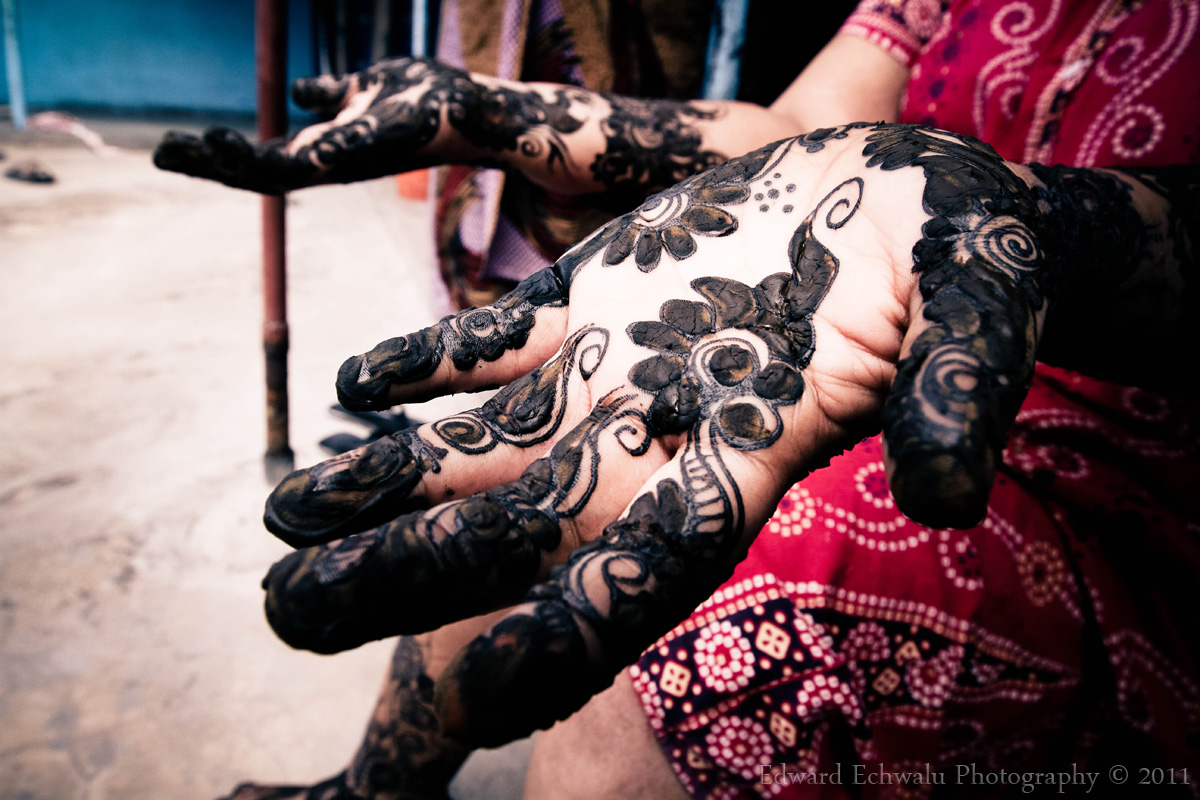 A woman displays henna designs