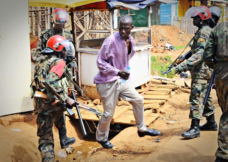 Military Police arrest a protester in Kireka during on April 18, 2011