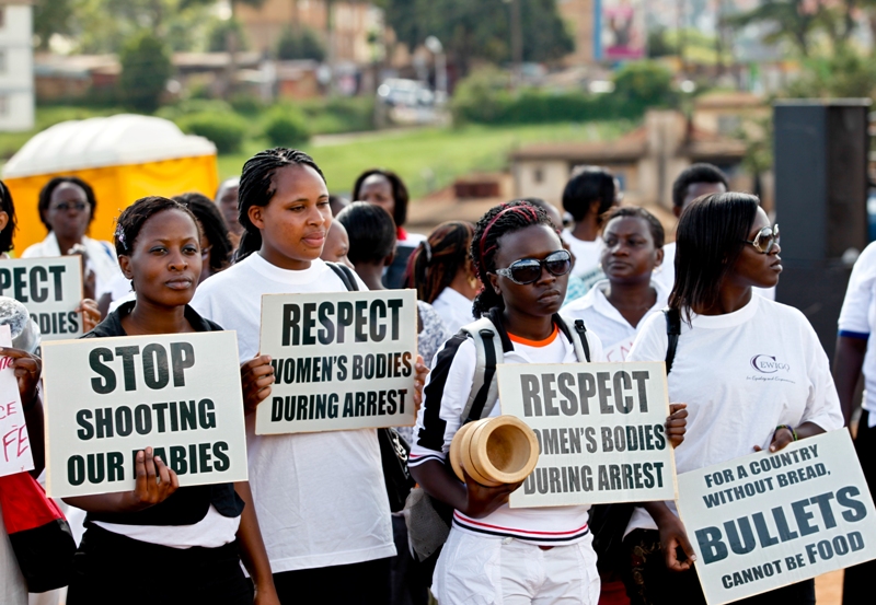 Women subscribing to the Uganda women's civil society organizations hold screaming placards before marching at Kiira Road play ground