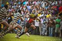 A Ugandan Rugby player runs past Zimbabwean players at Kyadondo Rugby Grounds in the opening game of Group 1B of the Confederation of African Rugby (CAR) which also includes Madagascar on June 12, 2011. Uganda lost the game 15-25.